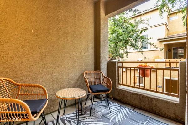 a view of a chair and table in the balcony