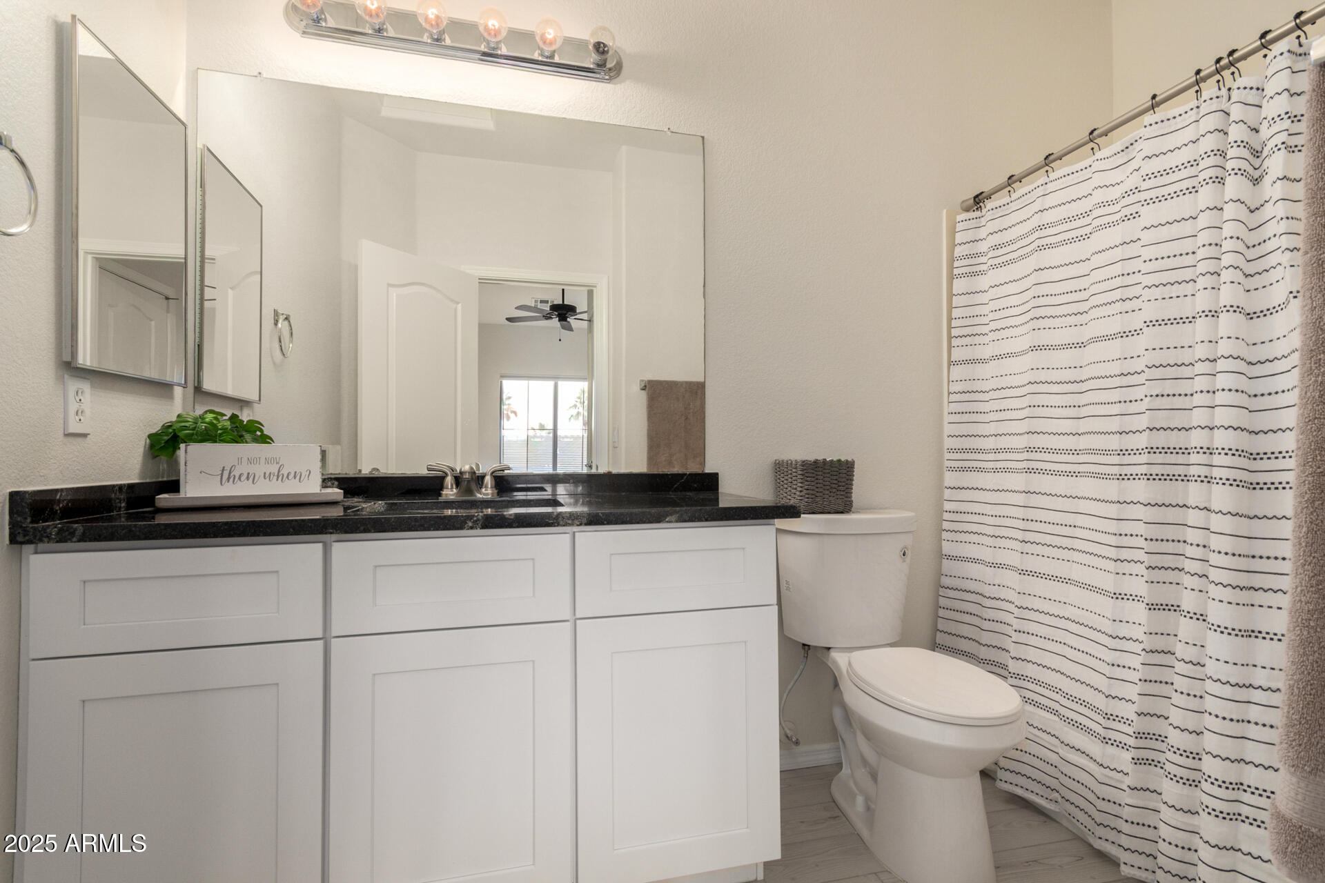 240 West Juniper Avenue, Unit 1010 Gilbert, AZ 85233 - Photo 19 of 46 a bathroom with a toilet a sink and mirror