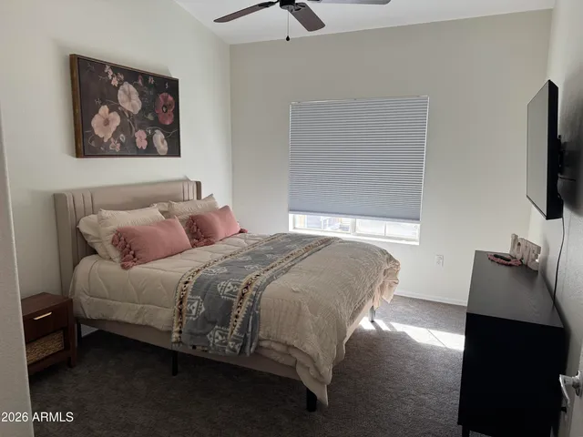 a bedroom with a bed and a flat screen tv