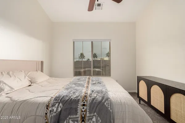 a bedroom with a bed and window
