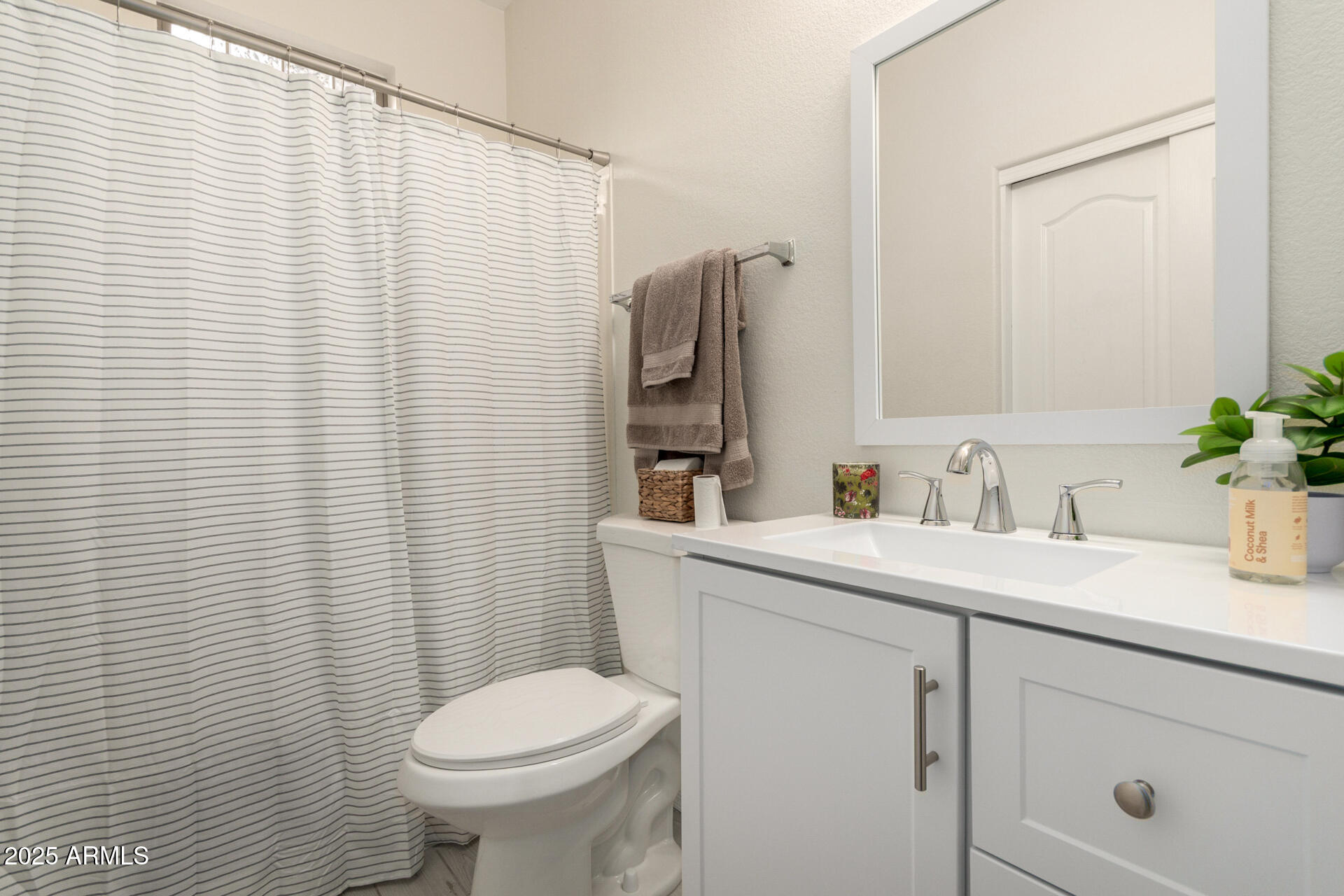 240 West Juniper Avenue, Unit 1010 Gilbert, AZ 85233 - Photo 21 of 46 a bathroom with a sink a toilet and mirror