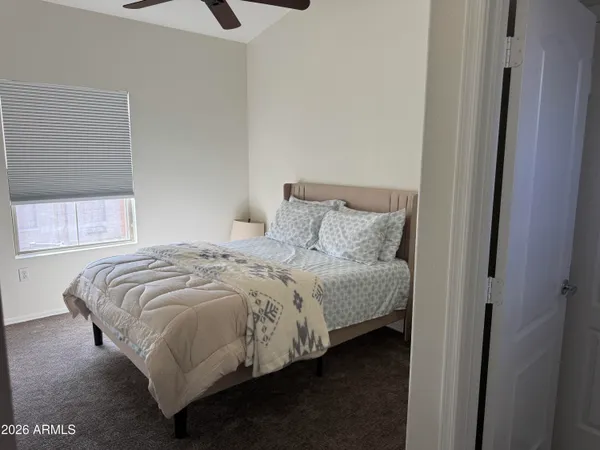 a bedroom with a bed and window