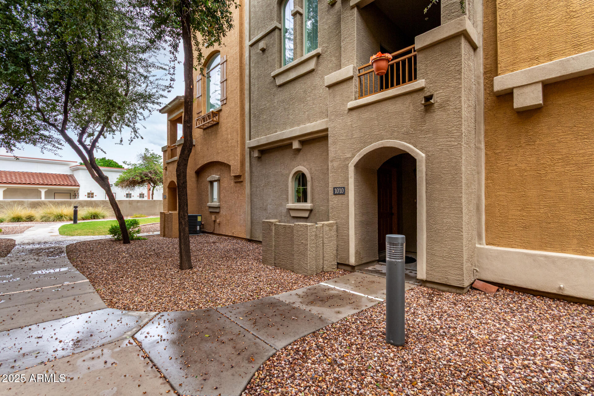 240 West Juniper Avenue, Unit 1010 Gilbert, AZ 85233 - Photo 24 of 46 a front view of a house with a yard