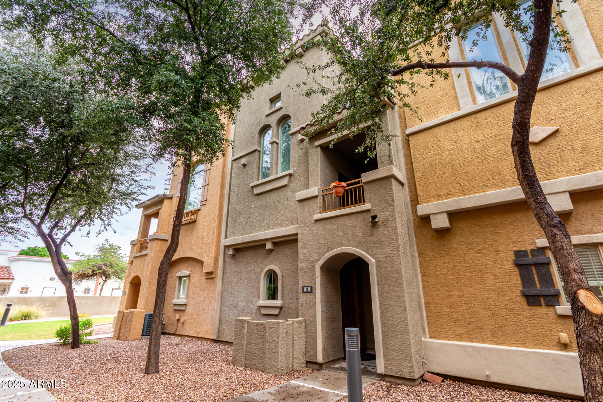 240 West Juniper Avenue, Unit 1010 Gilbert, AZ 85233 - Photo 25 of 46 a front view of a house with garage