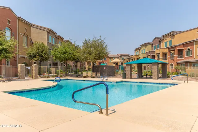 a view of a swimming pool with outdoor seating