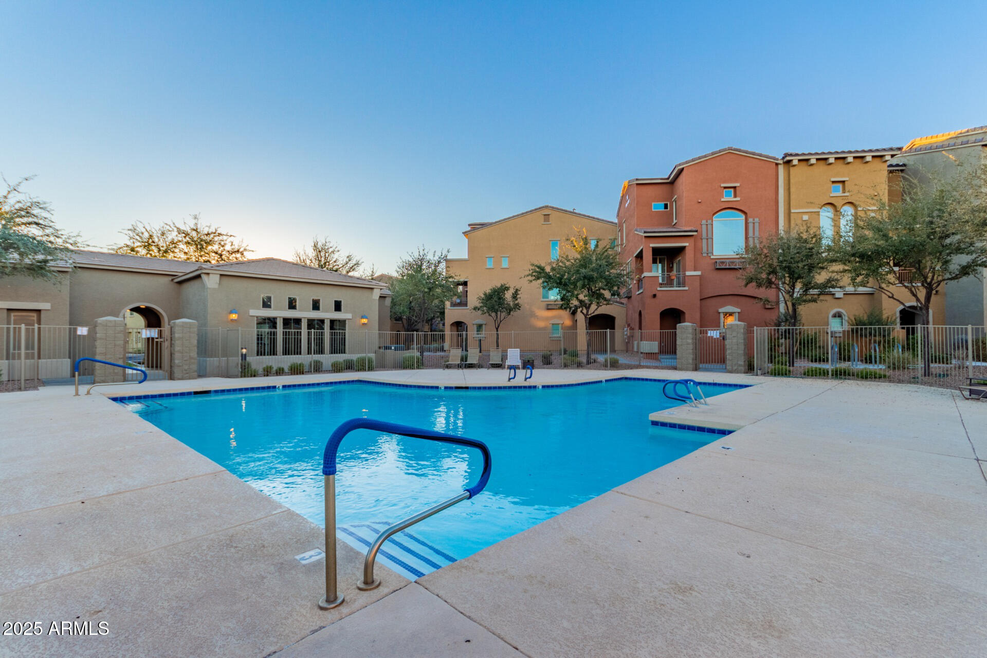 240 West Juniper Avenue, Unit 1010 Gilbert, AZ 85233 - Photo 38 of 46 a view of a chairs and table in patio with a swimming pool