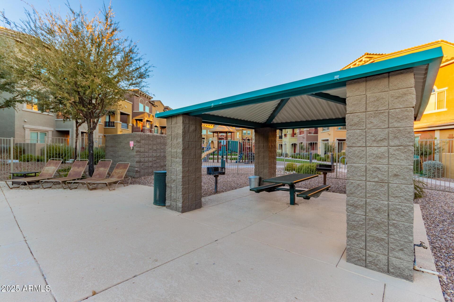 240 West Juniper Avenue, Unit 1010 Gilbert, AZ 85233 - Photo 39 of 46 a view of a patio with table and chairs under an umbrella