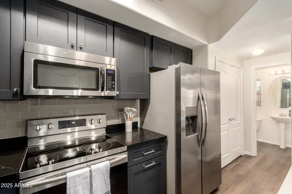 a kitchen with stainless steel appliances and wooden cabinets