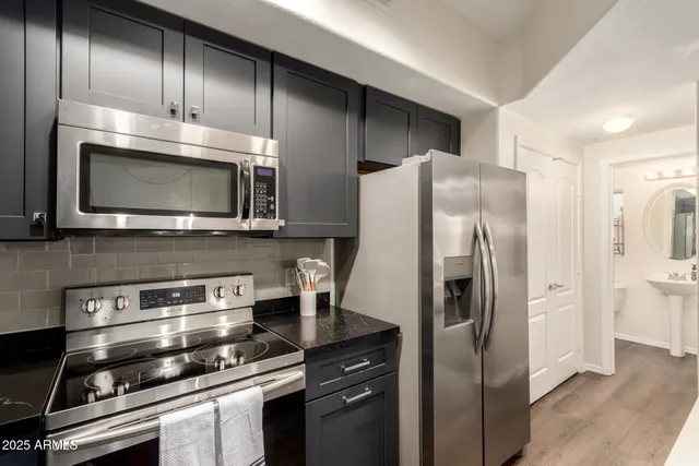 a kitchen with stainless steel appliances and wooden cabinets