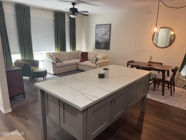 a view of kitchen island with furniture and wooden floor