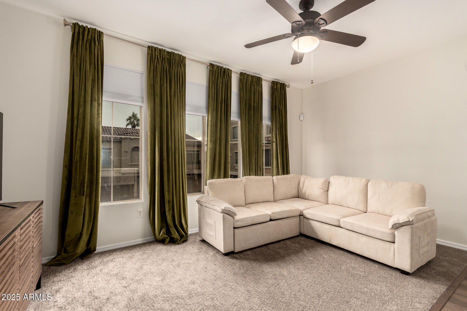 240 West Juniper Avenue, Unit 1010 Gilbert, AZ 85233 - Photo 10 of 46 a living room with furniture and a chandelier