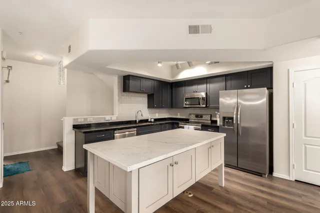 a kitchen with a stove a refrigerator and a sink
