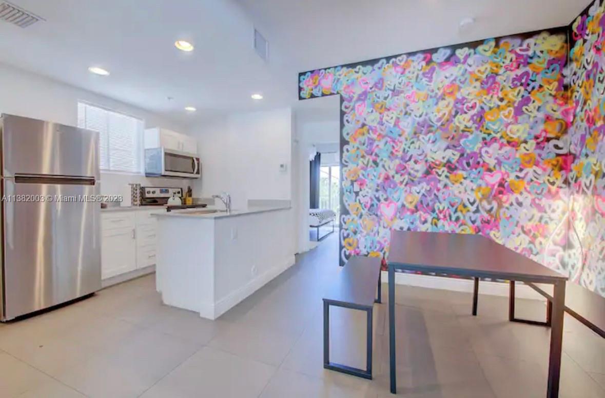 Wynwood Miami, FL 33127 - Photo 1 of 16 a kitchen with stainless steel appliances kitchen island granite countertop a refrigerator and a stove top oven