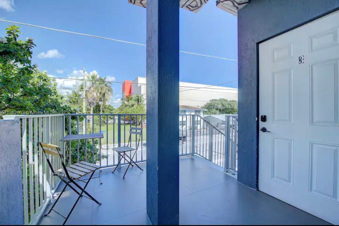 Wynwood Miami, FL 33127 - Photo 12 of 16 a view of a balcony with furniture and floor to ceiling window