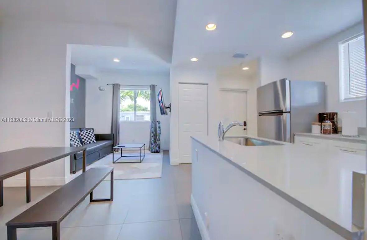 Wynwood Miami, FL 33127 - Photo 4 of 16 a large kitchen with stainless steel appliances a sink and a refrigerator