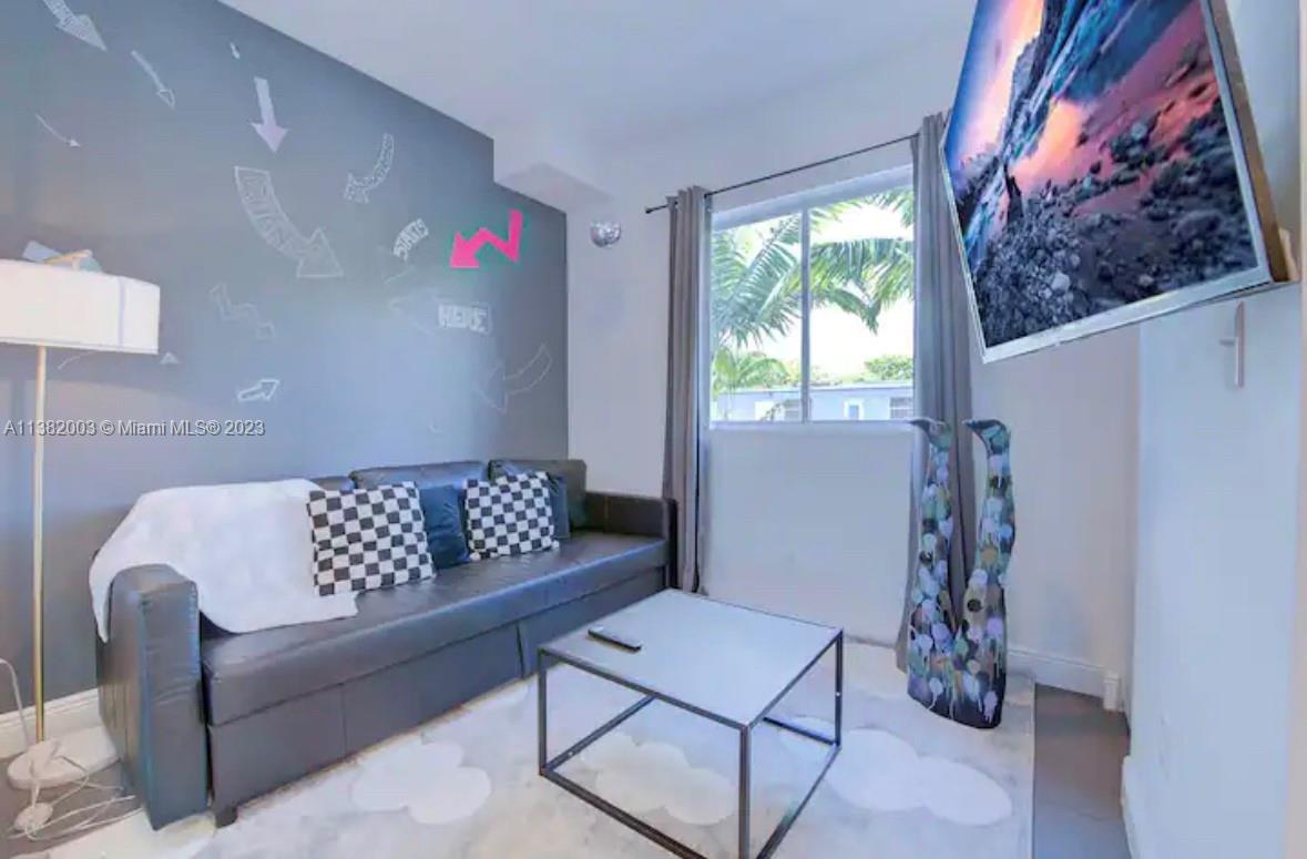 Wynwood Miami, FL 33127 - Photo 7 of 16 a living room with furniture and a window