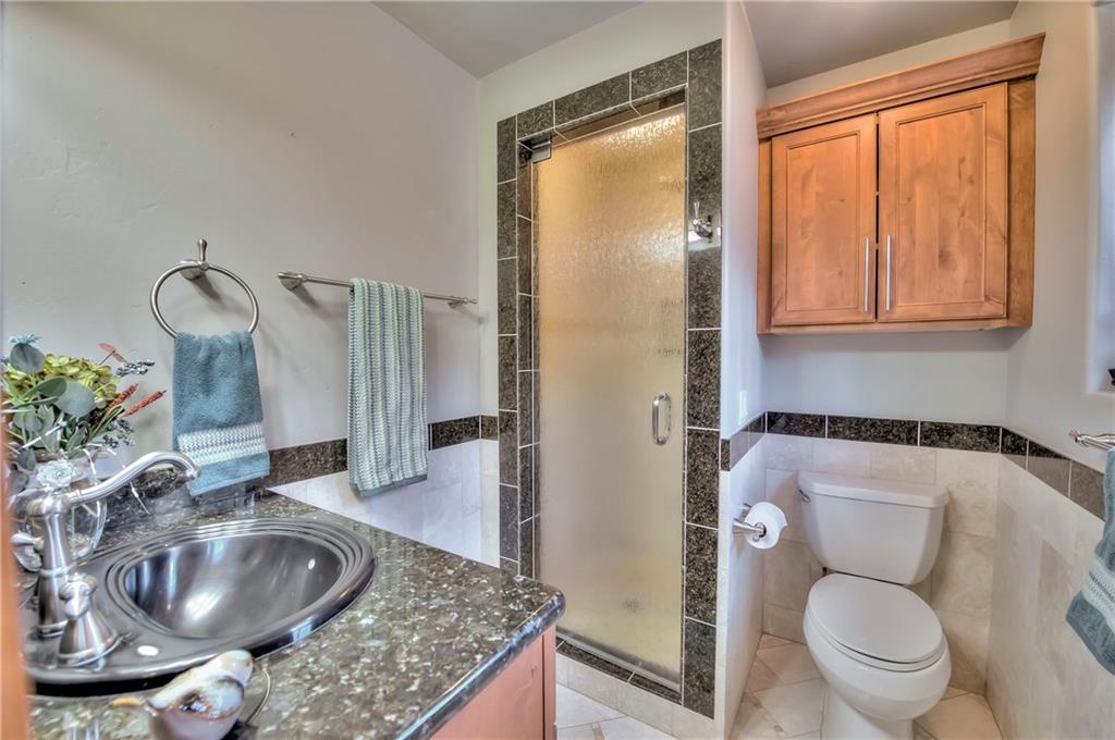 898 Deer Path Road Dillon, CO 80435 - Photo 21 of 34 a bathroom with a granite countertop sink and a mirror