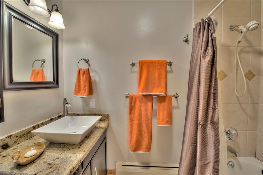 898 Deer Path Road Dillon, CO 80435 - Photo 25 of 34 a bathroom with a granite countertop sink and a mirror