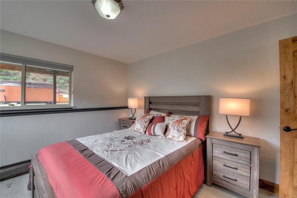 898 Deer Path Road Dillon, CO 80435 - Photo 27 of 34 a bedroom with a bed and a lamp on dresser
