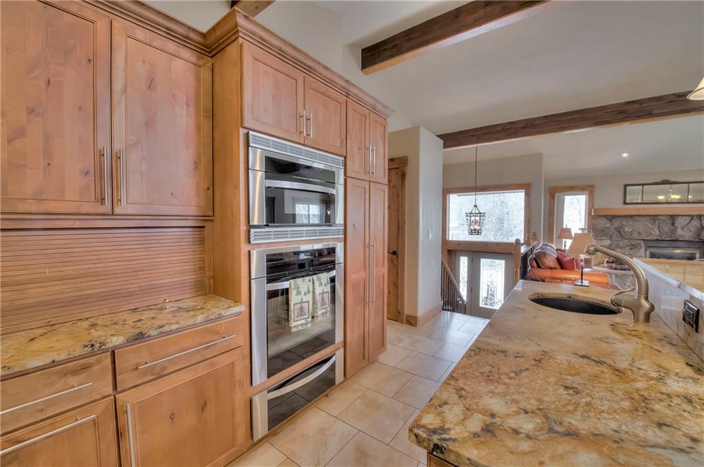 898 Deer Path Road Dillon, CO 80435 - Photo 6 of 34 a kitchen with granite countertop cabinets and refrigerator