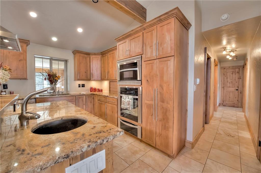 898 Deer Path Road Dillon, CO 80435 - Photo 8 of 34 a kitchen with stainless steel appliances granite countertop a sink and a refrigerator