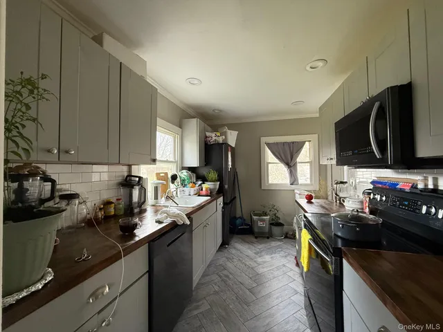 a kitchen with sink a stove and cabinets