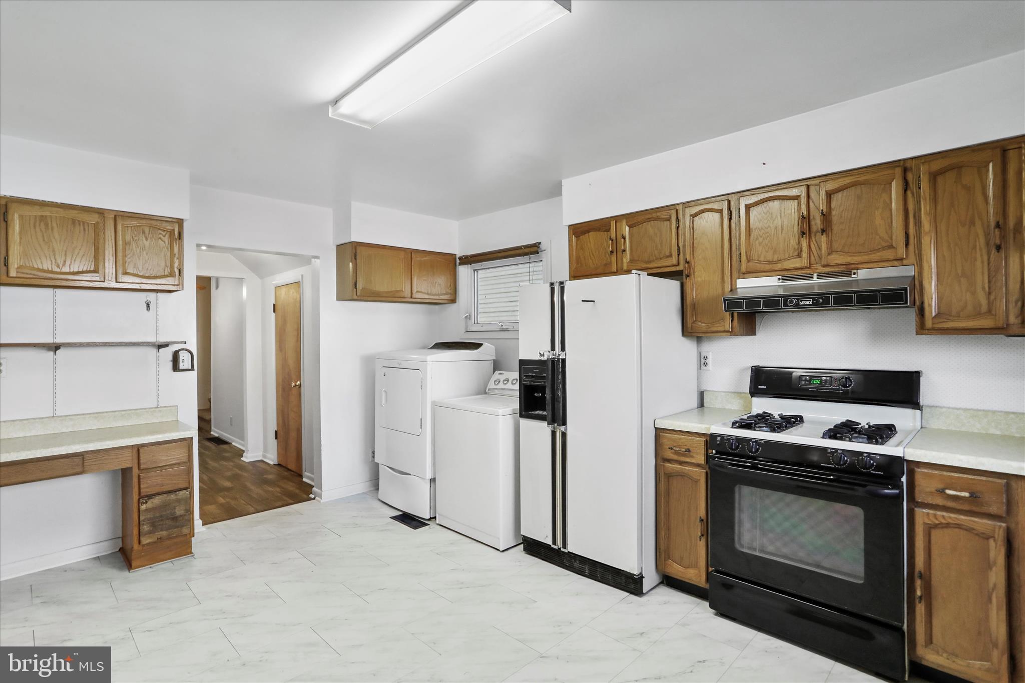 574 South Water Street Keyser, WV 26726 - Photo 11 of 25 a kitchen with a refrigerator a stove top oven a sink and cabinets