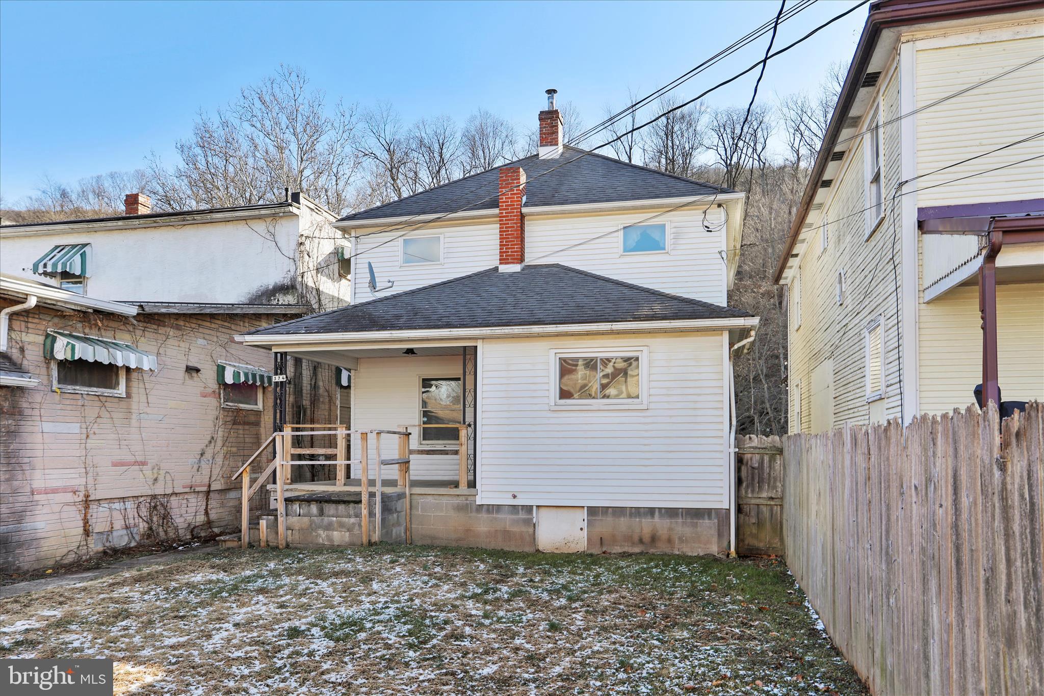 574 South Water Street Keyser, WV 26726 - Photo 23 of 25 a view of a white house with large windows and a small yard