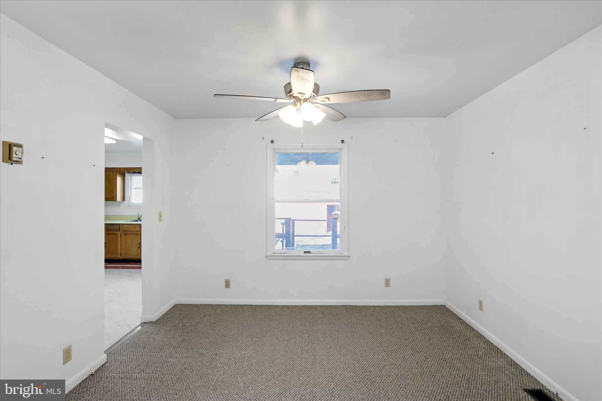 574 South Water Street Keyser, WV 26726 - Photo 7 of 25 an empty room with a window and a fan