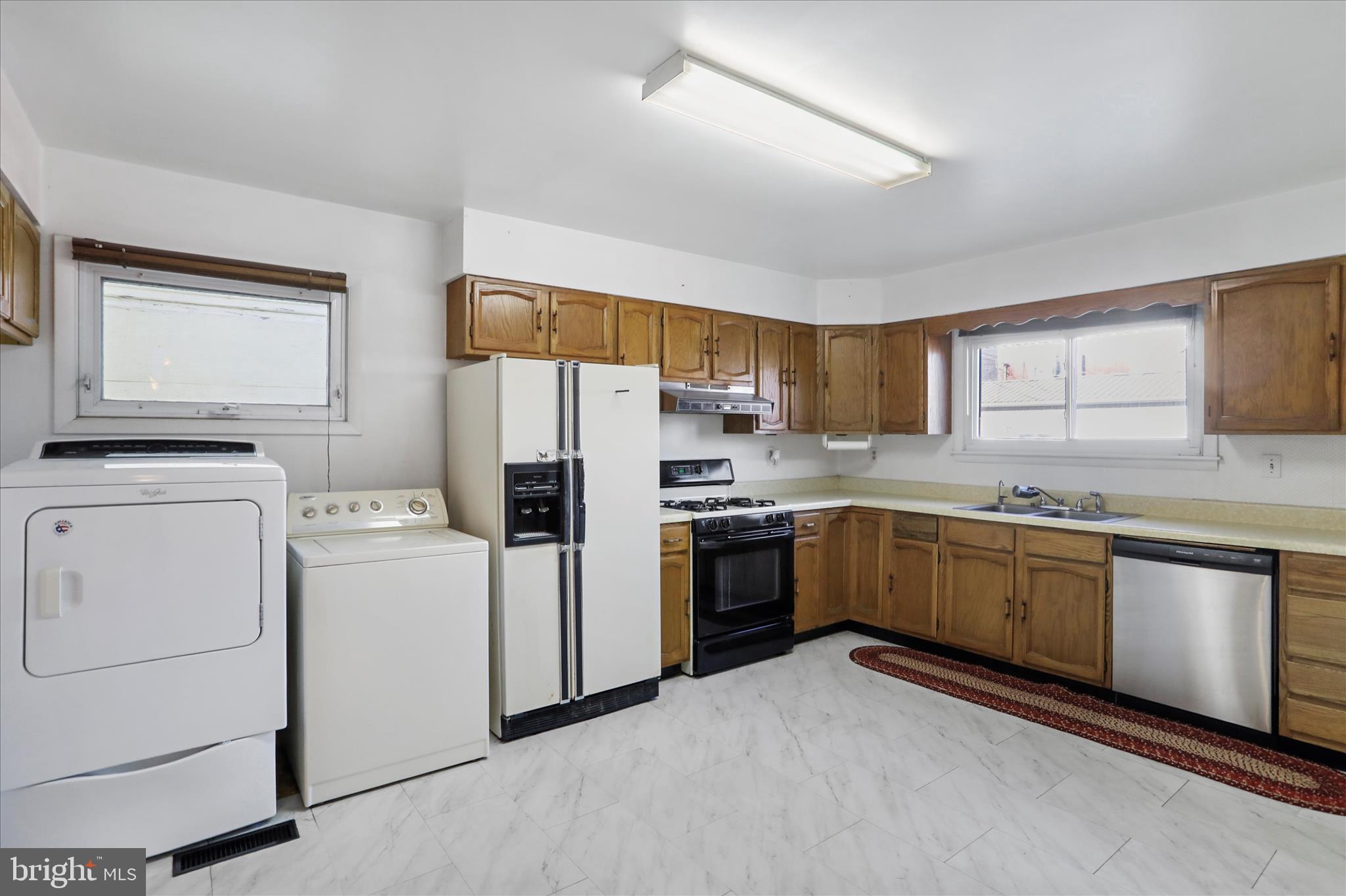 574 South Water Street Keyser, WV 26726 - Photo 9 of 25 a kitchen with refrigerator a sink and cabinets