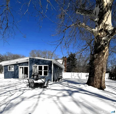 a view of a house with backyard and sitting area