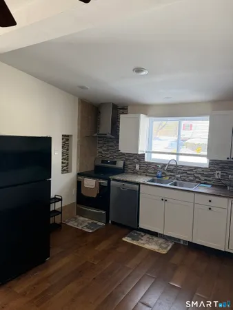 a kitchen with granite countertop a stove and a refrigerator
