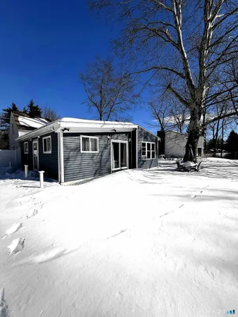 a view of a house with a snow in the yard