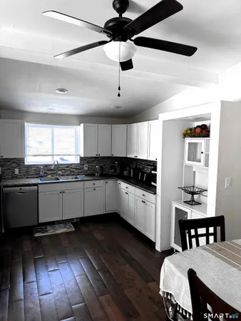 a kitchen with sink cabinets and wooden floor