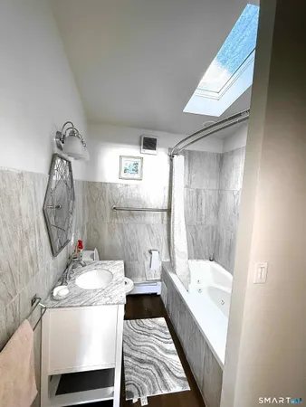 a bathroom with a bathtub and a shower