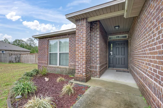 a view of house with backyard space and garden