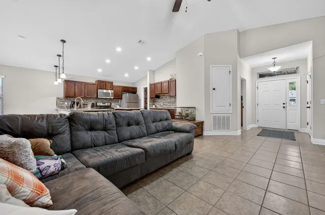 a living room with furniture and kitchen view