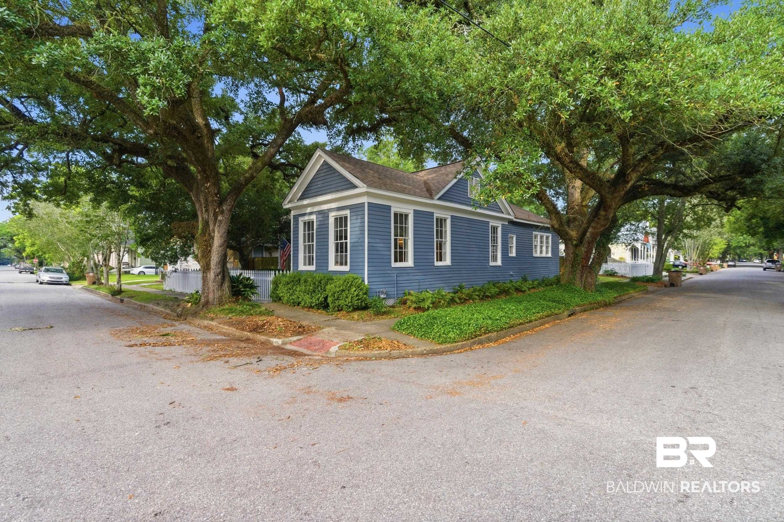 350 Charles Street Mobile, AL 36604 - Photo 37 of 52 Blue siding exterior featuring white trim and multiple windows