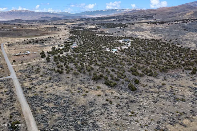 a view of a field with mountains in the background
