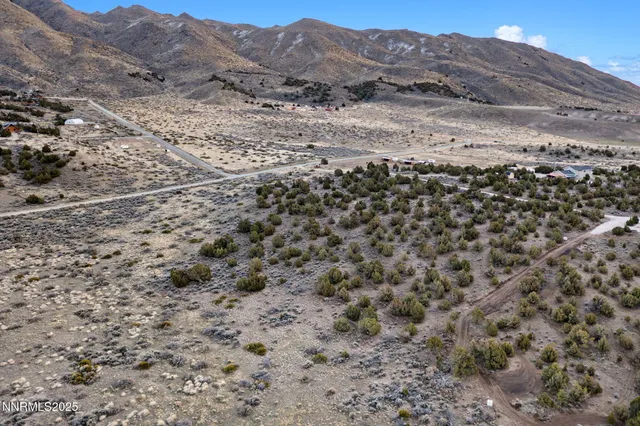 a view of a field with mountains in the background