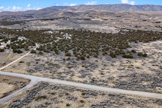 a view of a field with mountains in the background