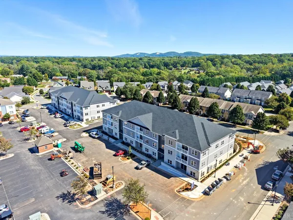 a kitchen with stainless steel appliances granite countertop a sink a stove a refrigerator a washer dryer and white cabinets