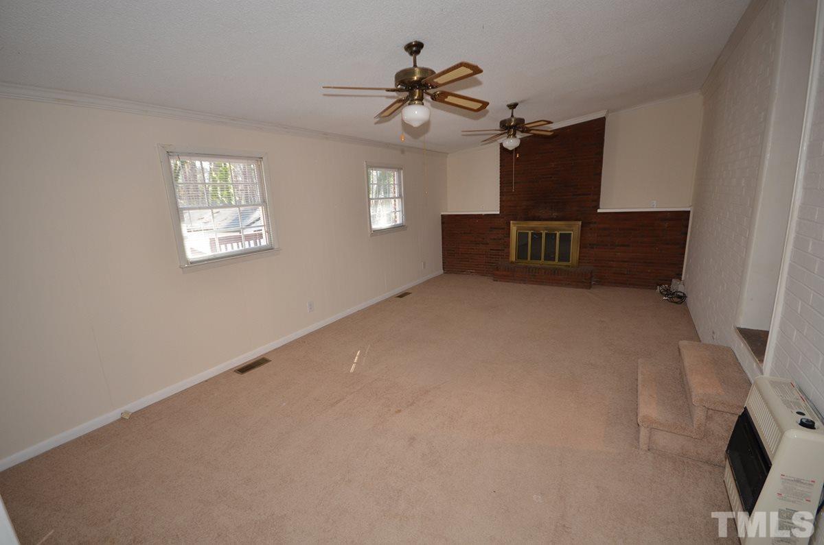4905 Revere Road Durham, NC 27713 - Photo 17 of 24 a view of a livingroom with a ceiling fan and window