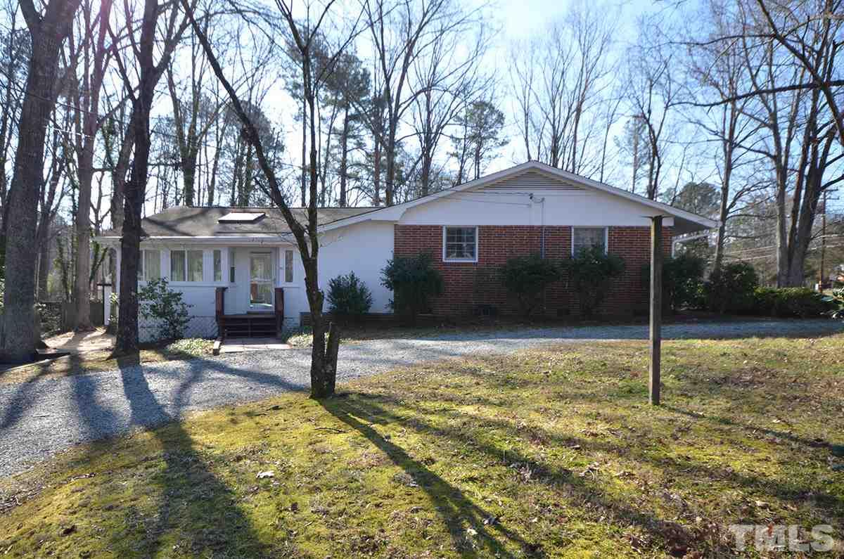 4905 Revere Road Durham, NC 27713 - Photo 3 of 24 a house with trees in front of it