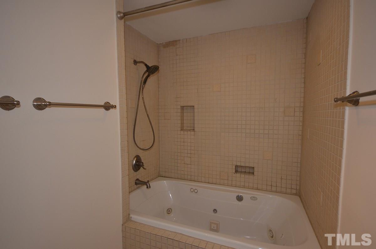 4905 Revere Road Durham, NC 27713 - Photo 21 of 24 a bathroom with a bath tub and a shower