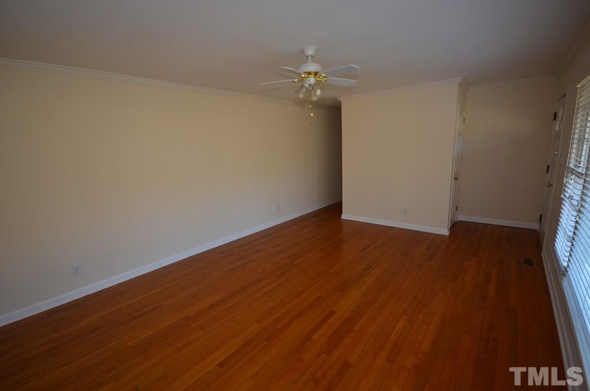 4905 Revere Road Durham, NC 27713 - Photo 6 of 24 a view of an empty room with wooden floor