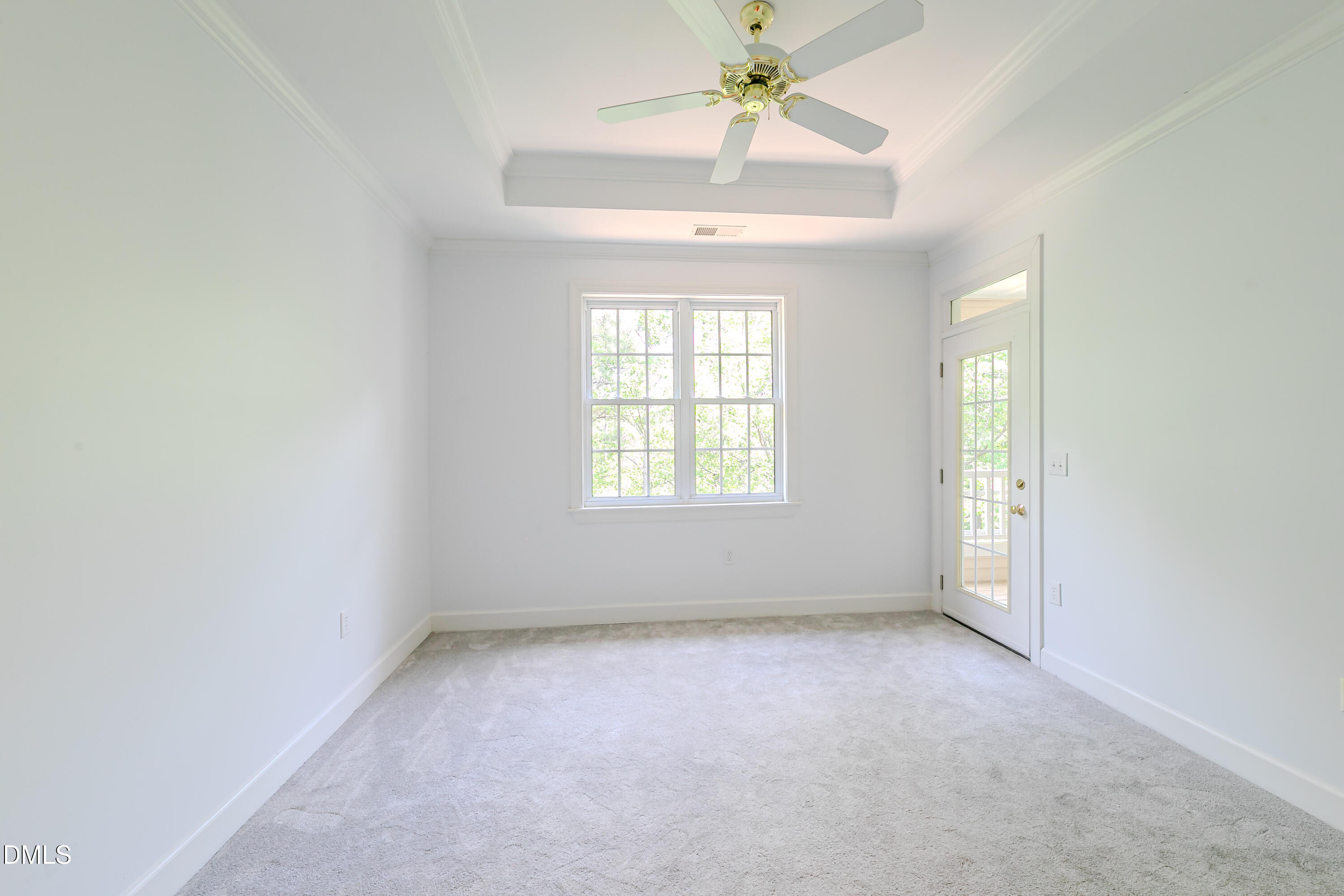 116 Northbrook Drive, Unit 305 Raleigh, NC 27609 - Photo 8 of 43 an empty room with a chandelier fan and windows