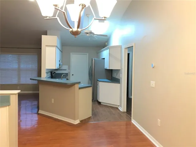 a kitchen with stainless steel appliances granite countertop a sink a stove and a refrigerator