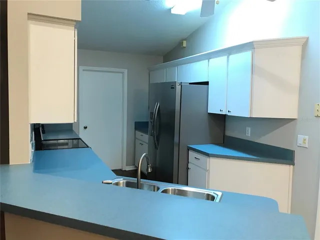a kitchen with stainless steel appliances a refrigerator and a stove