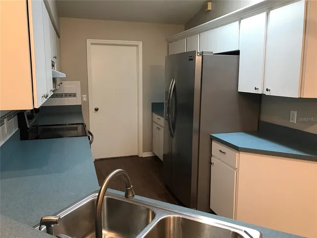 a kitchen with stainless steel appliances a refrigerator and a sink